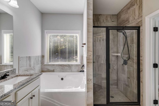 bathroom featuring vanity and separate shower and tub