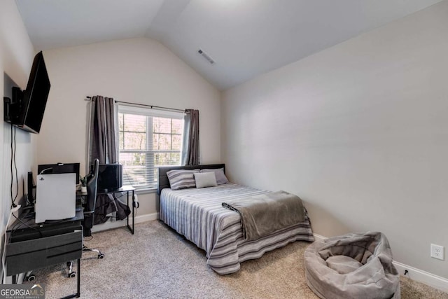 carpeted bedroom with lofted ceiling