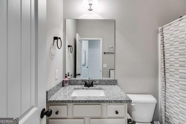 bathroom with vanity, a shower with curtain, and toilet