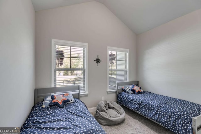 bedroom featuring carpet floors and vaulted ceiling