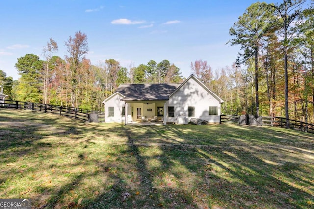 back of property with a patio and a lawn