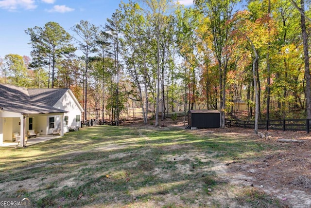 view of yard featuring a patio area and a jacuzzi