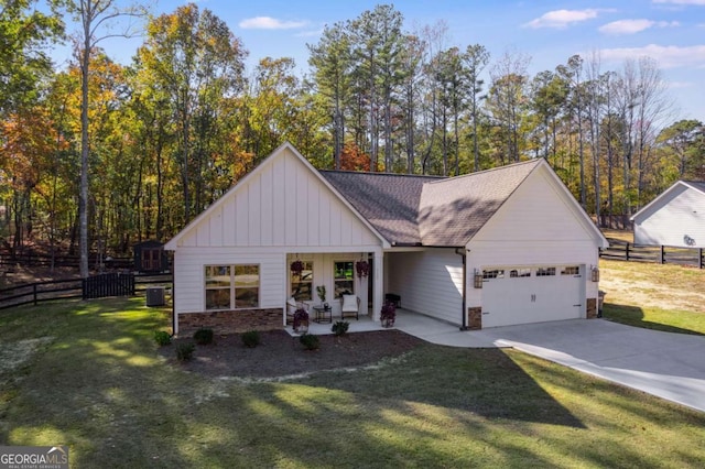 view of front facade featuring a garage, covered porch, and a front lawn