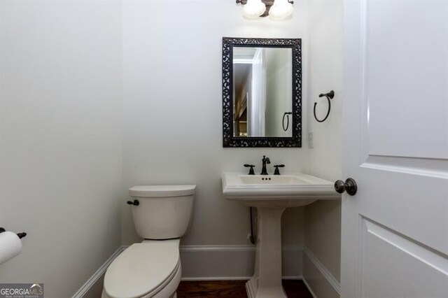 unfurnished room featuring wood-type flooring, ornamental molding, and a raised ceiling