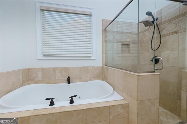 bathroom featuring shower with separate bathtub