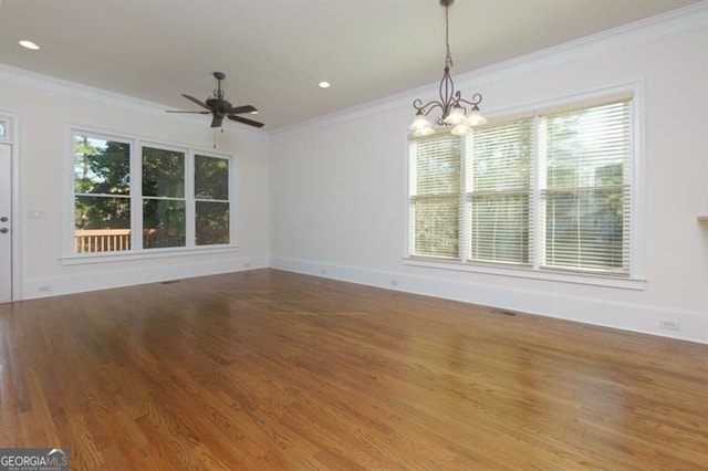 spare room with ceiling fan with notable chandelier, wood-type flooring, and ornamental molding