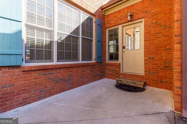 entrance to property featuring a patio area