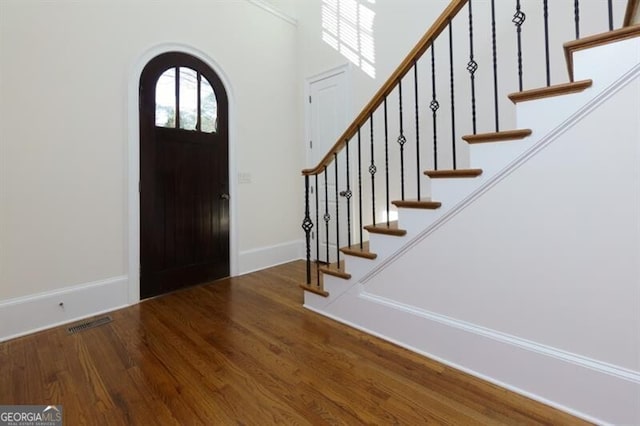 foyer with dark wood-type flooring