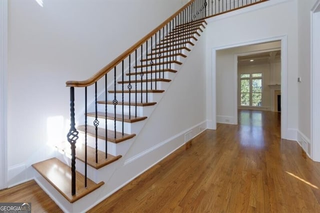 stairs with wood-type flooring