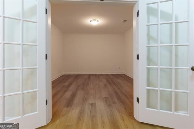 interior space with ornamental molding and light wood-type flooring