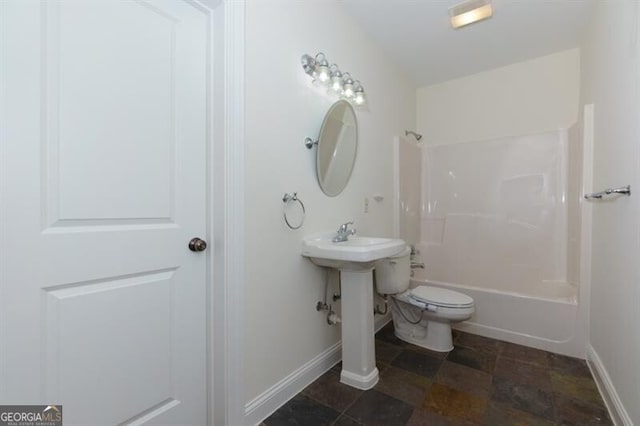 bathroom featuring tub / shower combination and toilet