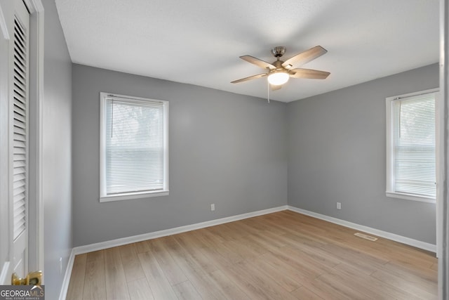 unfurnished room with ceiling fan and light hardwood / wood-style flooring