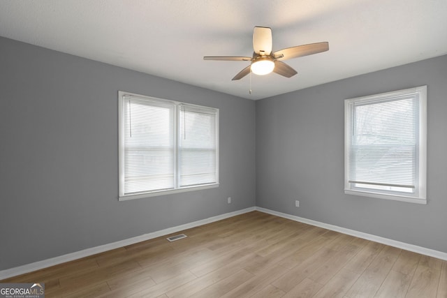 empty room featuring light hardwood / wood-style flooring and ceiling fan