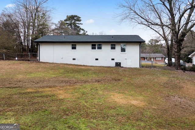 back of property featuring a lawn