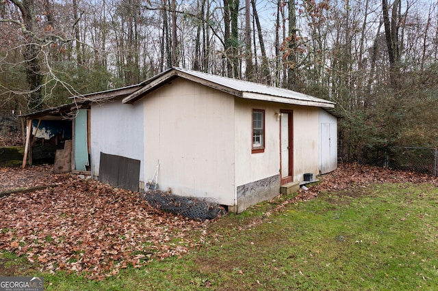 view of outbuilding with a lawn