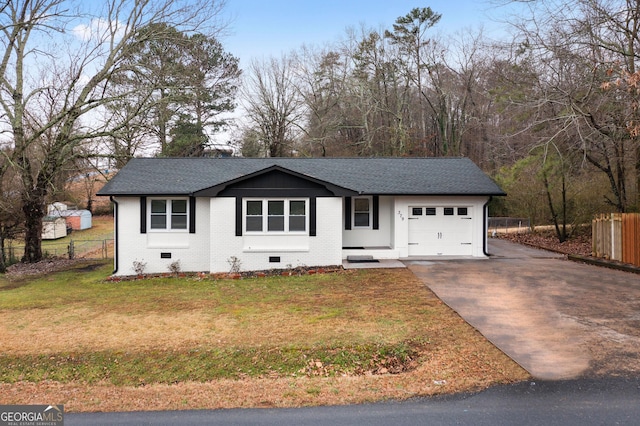 view of front of property with a garage and a front lawn