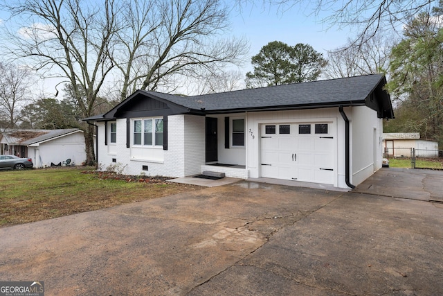 ranch-style house featuring a garage and a front yard