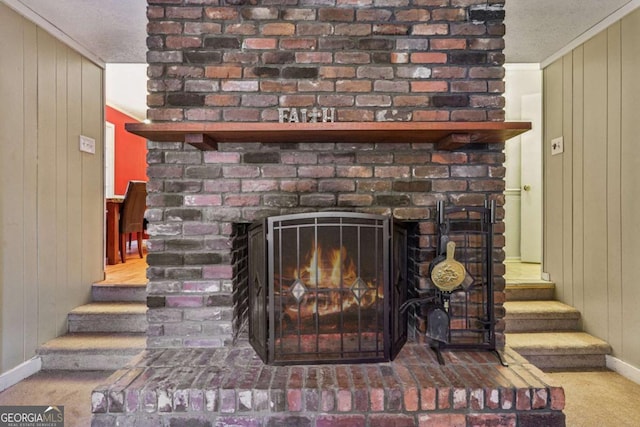 room details with crown molding, carpet flooring, a fireplace, and wooden walls