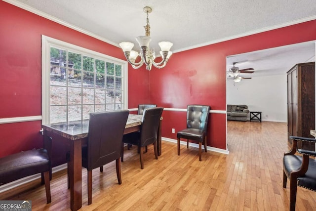 dining room featuring crown molding, ceiling fan with notable chandelier, a textured ceiling, and light hardwood / wood-style flooring