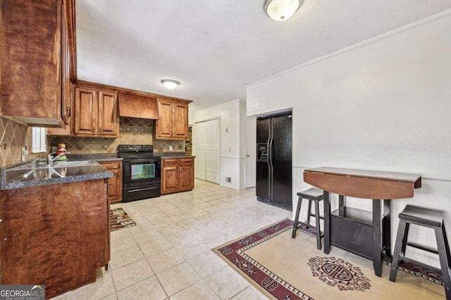 kitchen with light tile patterned flooring, custom exhaust hood, crown molding, black appliances, and backsplash