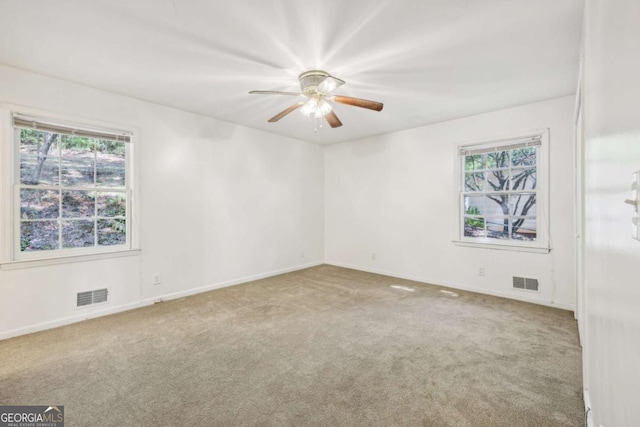 carpeted spare room with ceiling fan