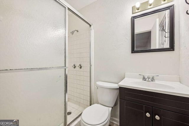 bathroom with an enclosed shower, vanity, and toilet