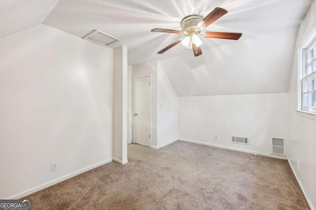 bonus room with lofted ceiling, light colored carpet, and ceiling fan