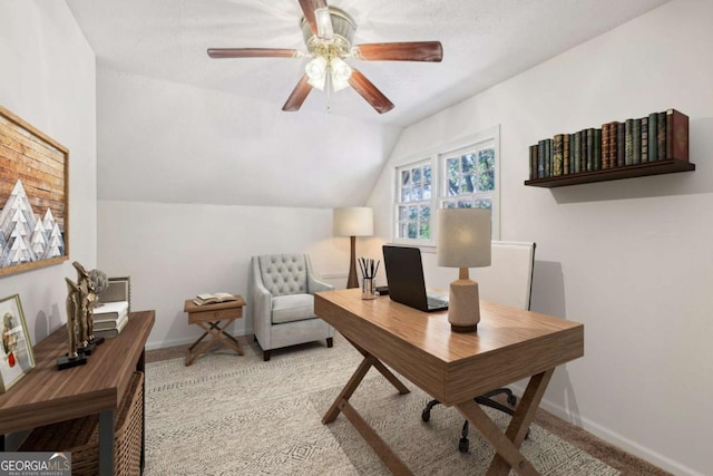 home office with vaulted ceiling, light carpet, and ceiling fan