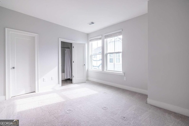 unfurnished bedroom with light colored carpet