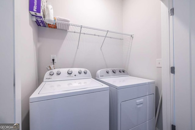 clothes washing area featuring washer and clothes dryer