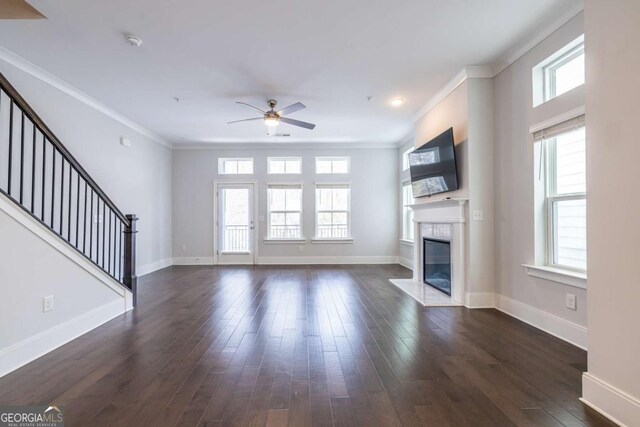 unfurnished living room featuring ceiling fan, ornamental molding, and dark hardwood / wood-style floors