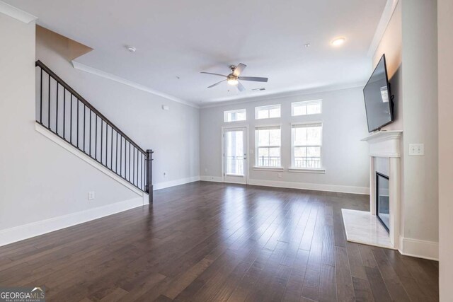 unfurnished living room featuring crown molding, dark wood-type flooring, and ceiling fan