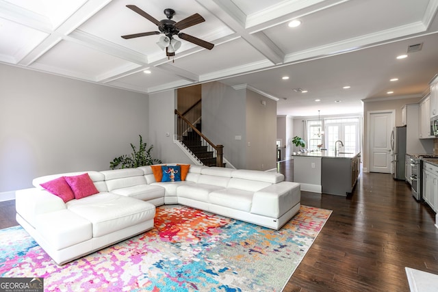 living room featuring coffered ceiling, ornamental molding, sink, and dark hardwood / wood-style floors