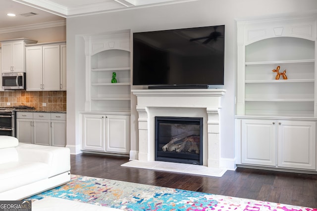 unfurnished living room featuring dark hardwood / wood-style flooring, built in features, and ornamental molding