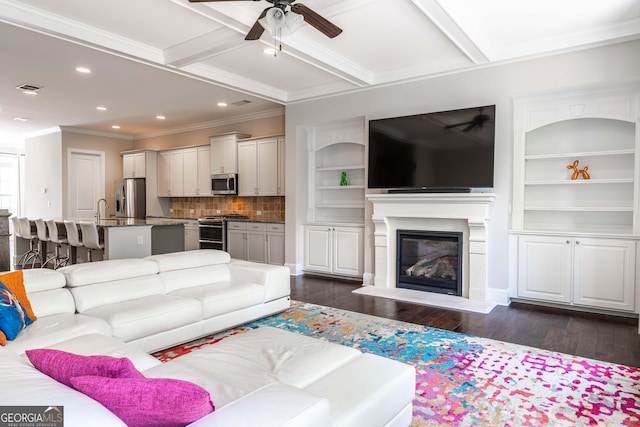 living room with coffered ceiling, ornamental molding, dark hardwood / wood-style floors, and ceiling fan