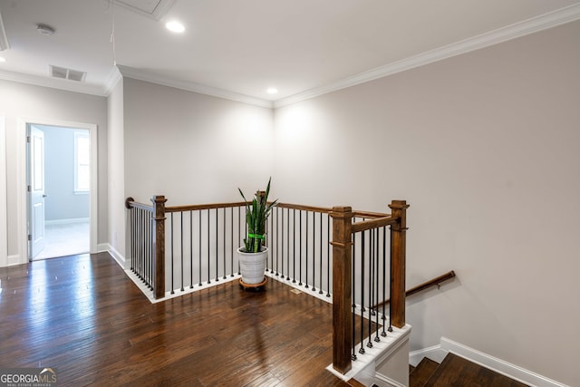 stairway featuring crown molding and hardwood / wood-style floors