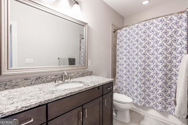 bathroom featuring vanity, tile patterned floors, and toilet