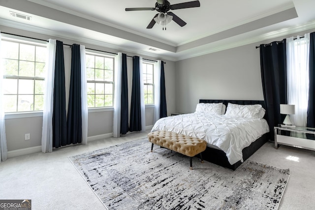 bedroom featuring crown molding, ceiling fan, a raised ceiling, and carpet