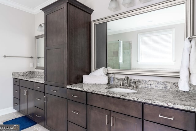 bathroom with crown molding, vanity, a shower with shower door, and tile patterned flooring