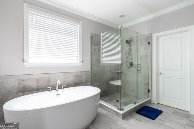 bathroom with independent shower and bath, ornamental molding, and tile walls