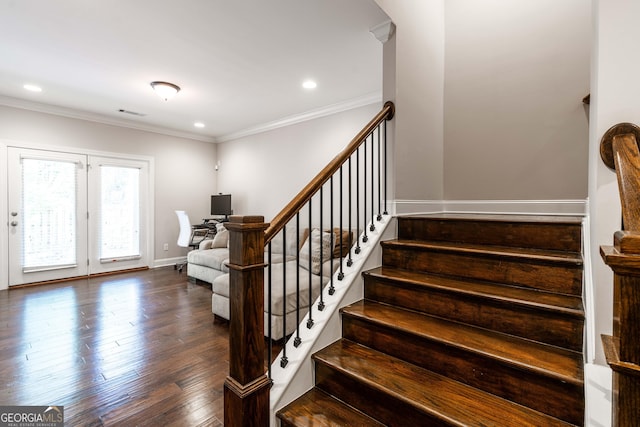 staircase with ornamental molding and hardwood / wood-style floors