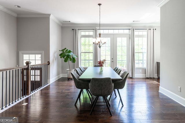 dining area with crown molding, dark hardwood / wood-style floors, and a chandelier