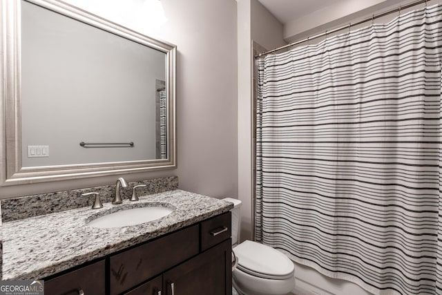 bathroom with walk in shower, vanity, and toilet