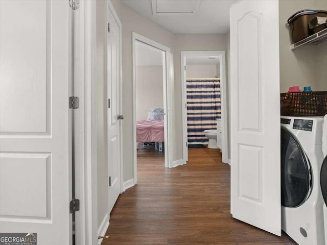 laundry room featuring dark hardwood / wood-style flooring and washer / dryer