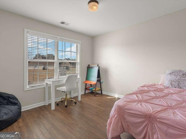 bedroom featuring dark hardwood / wood-style flooring