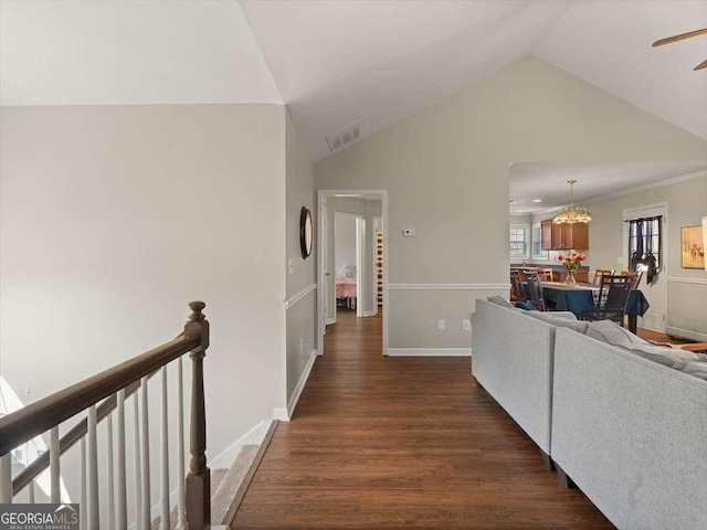 hallway featuring dark hardwood / wood-style floors and vaulted ceiling