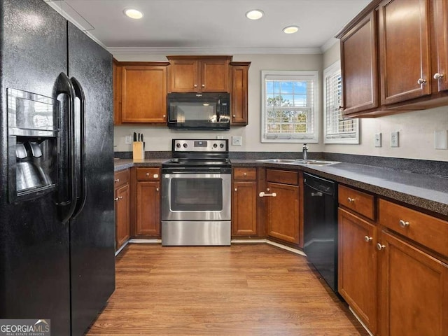 kitchen featuring light hardwood / wood-style flooring, sink, ornamental molding, and black appliances