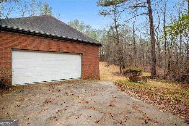 view of side of property featuring a garage and an outdoor structure