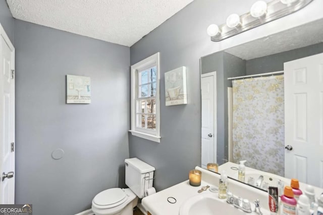 bathroom featuring a textured ceiling and toilet