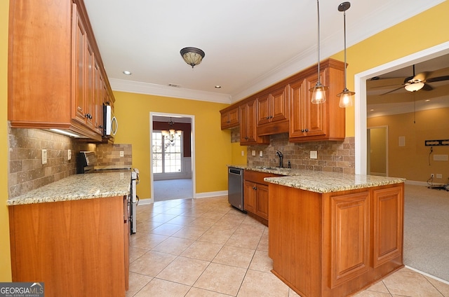 kitchen featuring sink, light stone counters, crown molding, decorative light fixtures, and stainless steel appliances